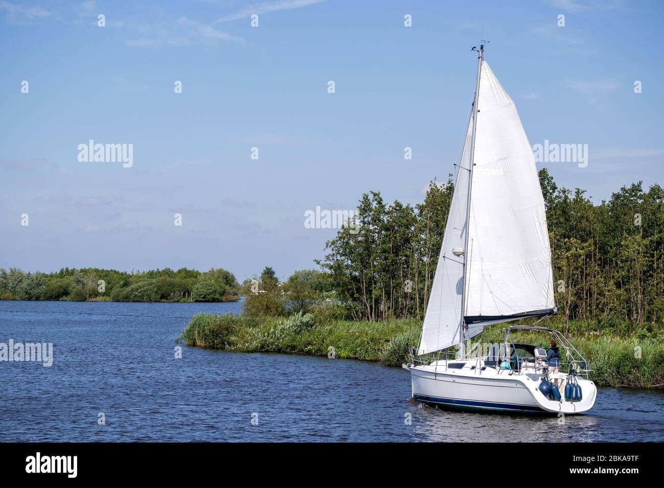 sailing boat in Dutch waterscape Stock Photo