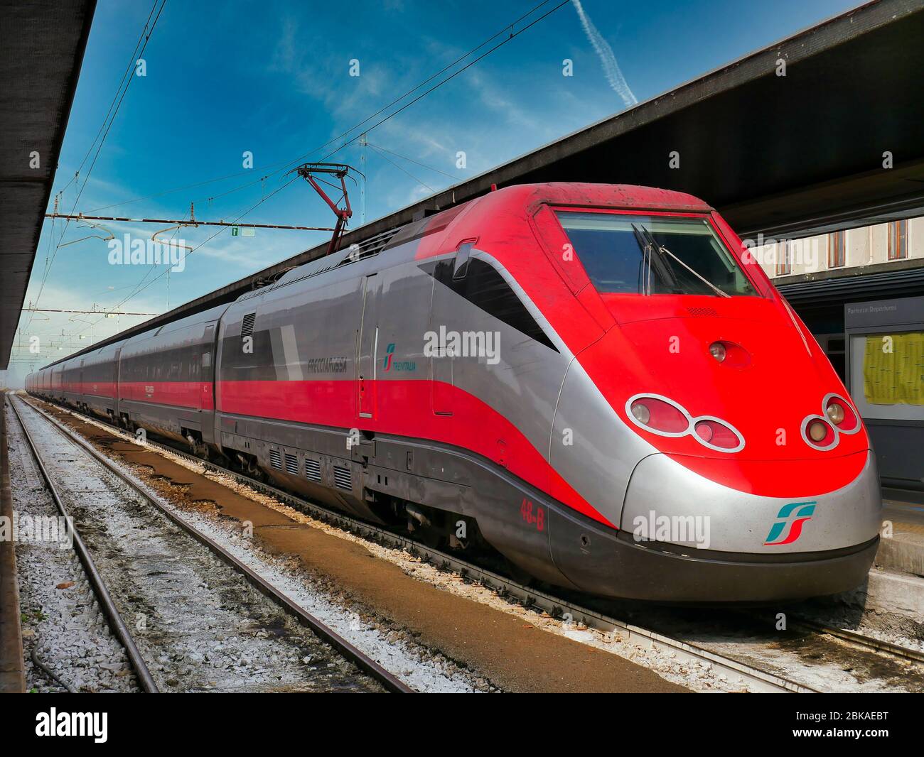 The engine and carriages of a Trenitalia (national rail operator, Italy) Frecciarossa (red arrow) high speed train waiting at the station in Venice on Stock Photo