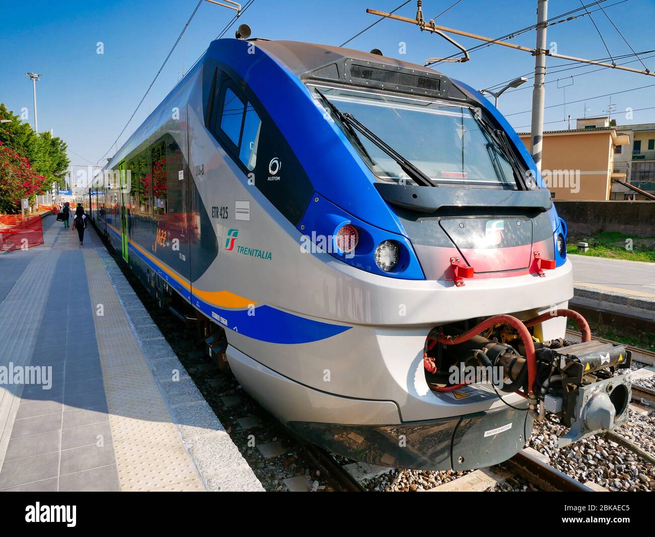 The engine of an Italian regional train (type ETR 427) waiting at the platform at Pompeii Station on a sunny day with blue sky Stock Photo
