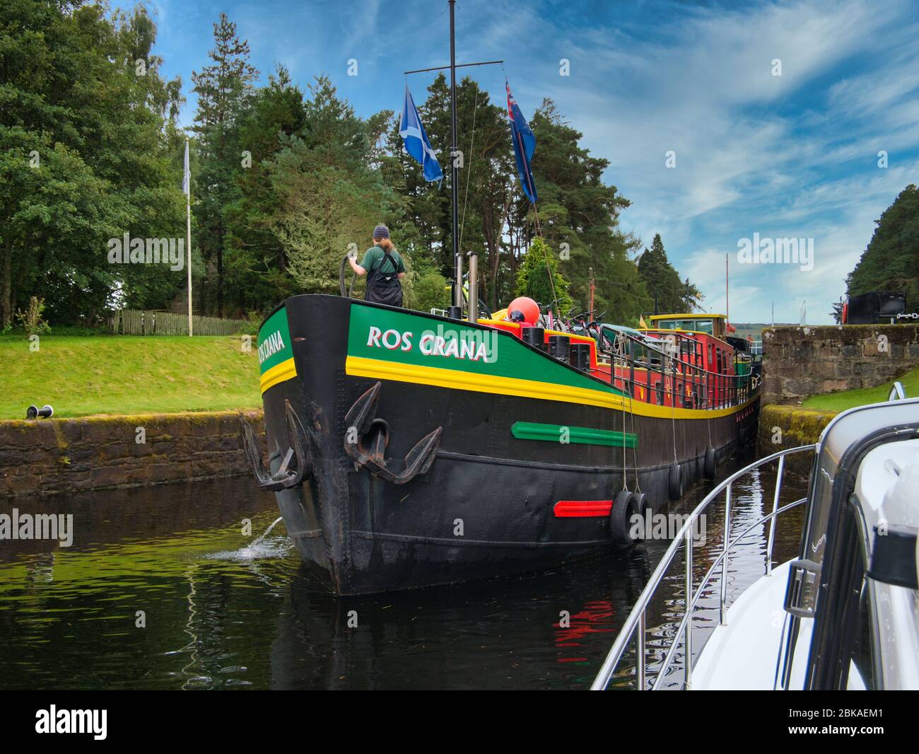 Dutch hotel barge Ros Crana exits a lock on the Caledonian Canal in the Scottish Highlands, Scotland. Stock Photo