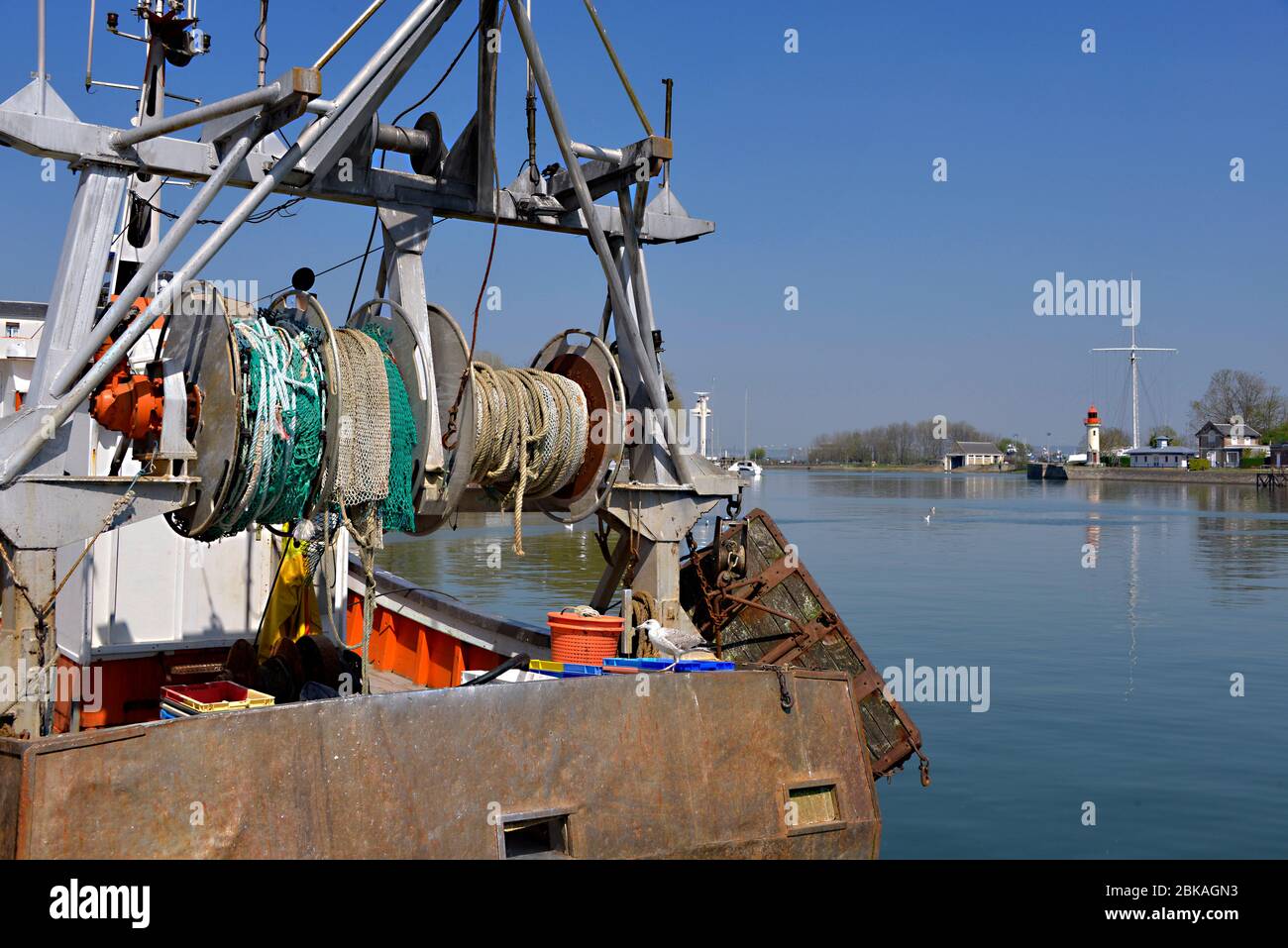 Fishing trawler and lighthouse in the port of Honfleur, commune in the Calvados department in the lower Normandy region in northwestern France Stock Photo
