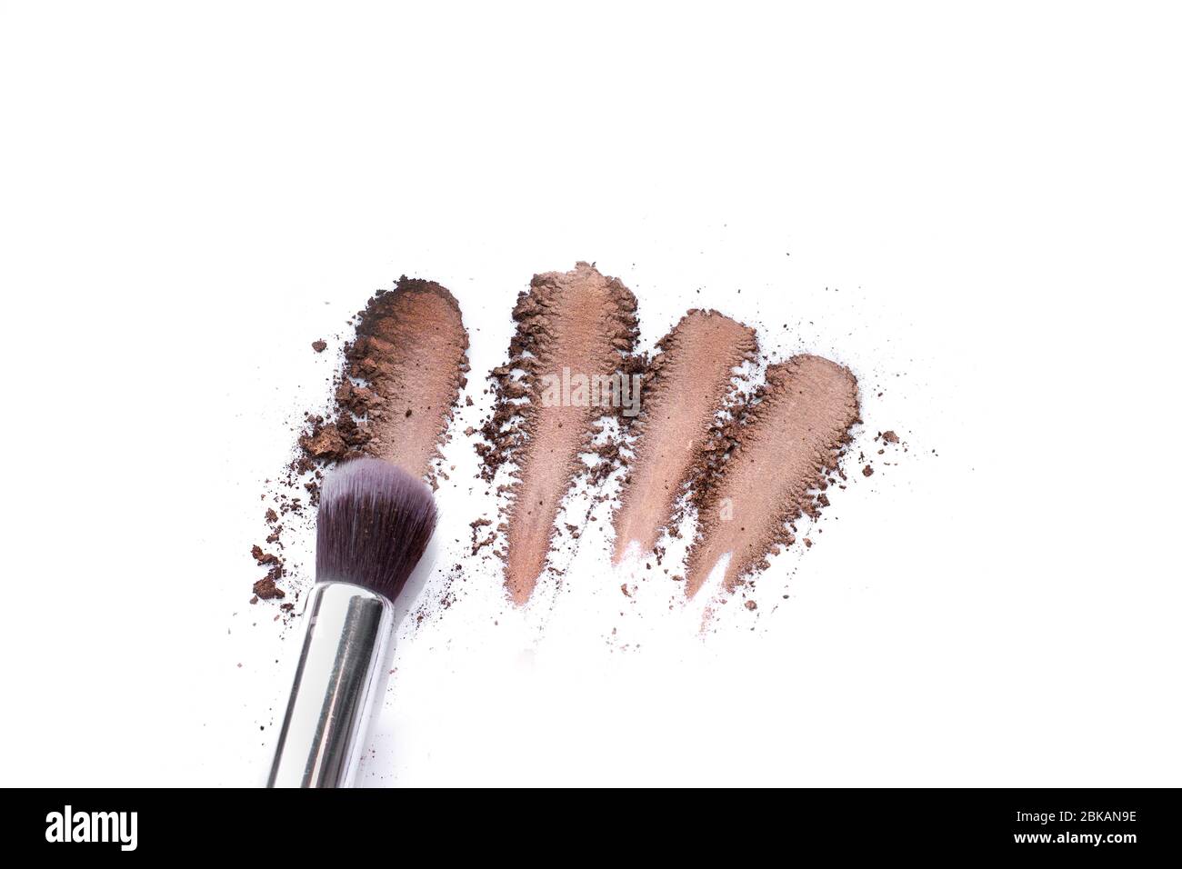 Make up brushes and brown eye shadows on black background. Stock Photo