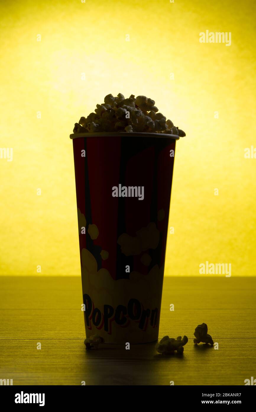 Bag full of popcorn with yellow background Stock Photo Alamy