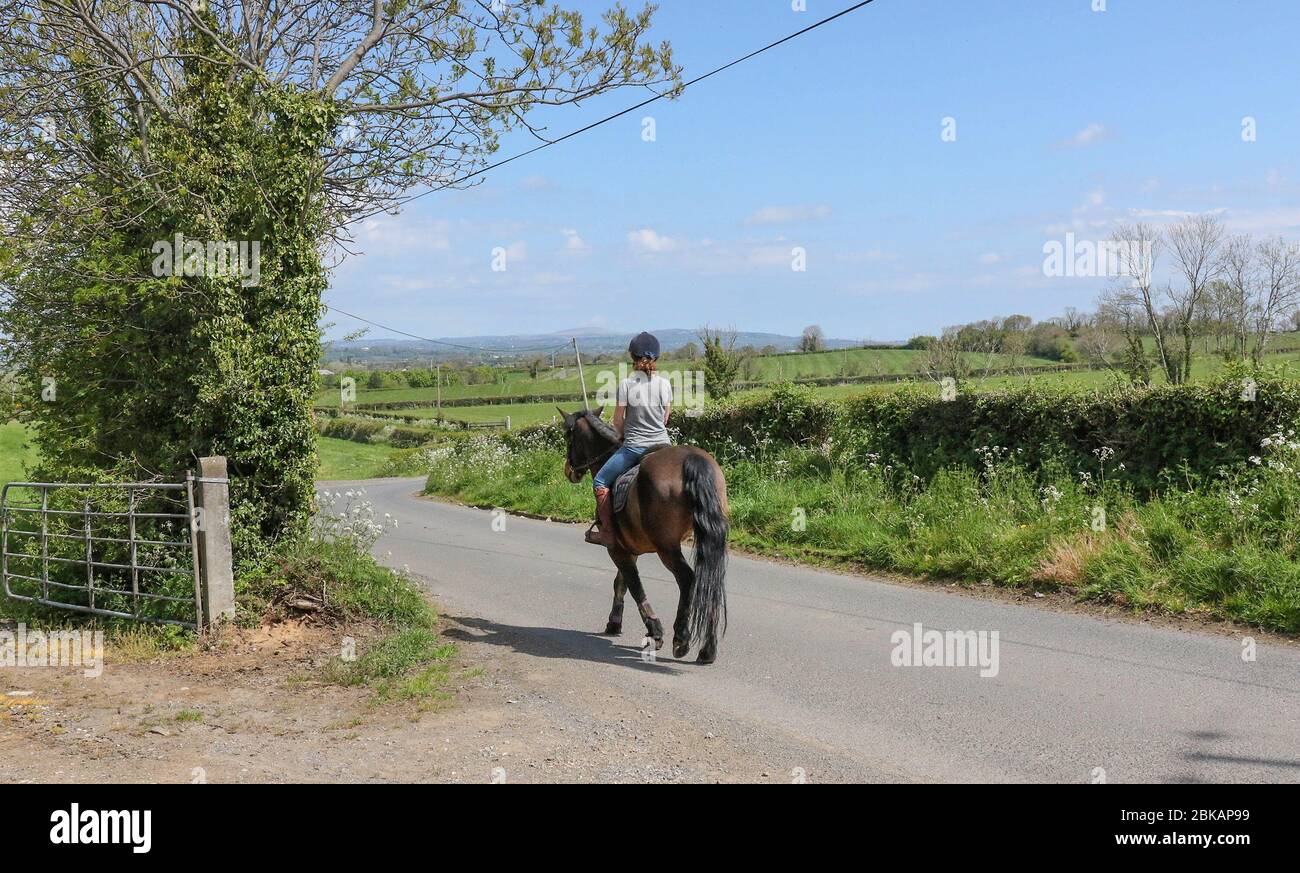 Magheralin, County Armagh, Northern Ireland. 03rd May, 2020. UK weather - overcast with threatening cloud but warm when the sun breaks through. Horse-rdining in the spring sunshine. Credit: CAZIMB/Alamy Live News. Stock Photo