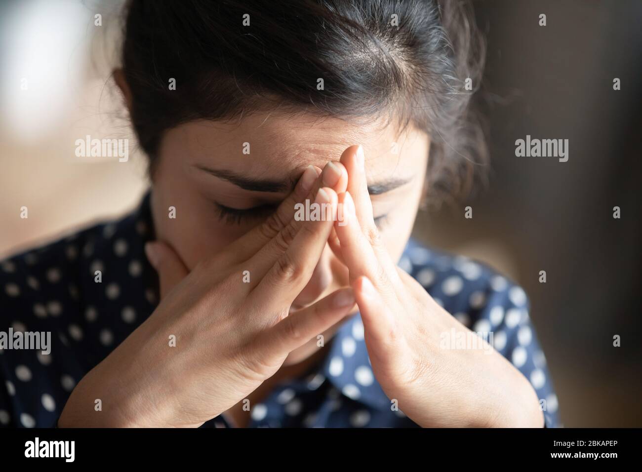 Head shot depressed young indian woman feeling exhausted. Stock Photo
