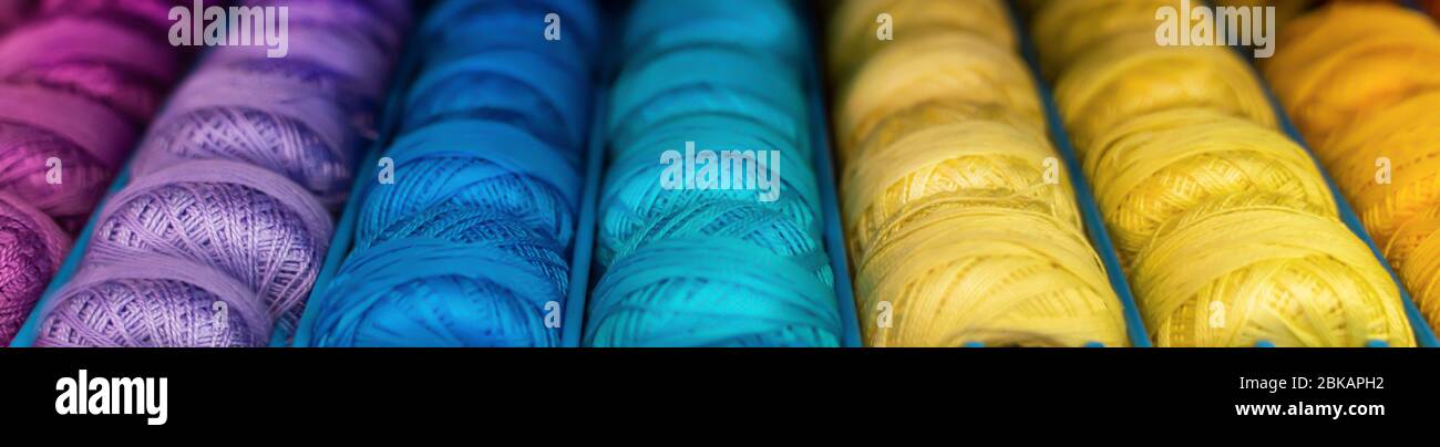 skeins of colored woolen threads background. Stock Photo