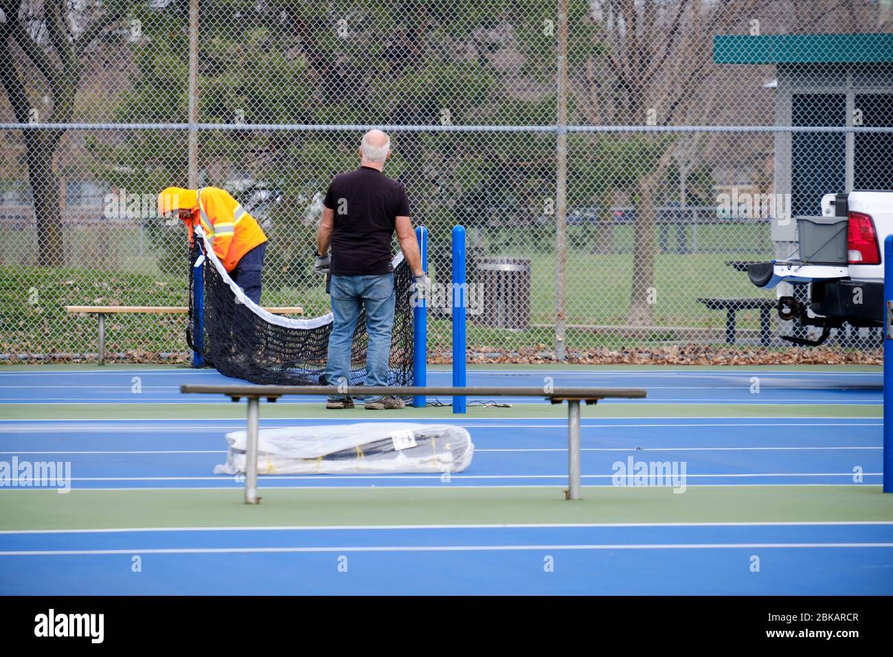 Montreal, Quebec, Canada. May 3rd, 2020. As the city slowly prepares for  the relaxation of rules, municipal employees install nets in the Louis-Riel  park tennis courts Stock Photo - Alamy