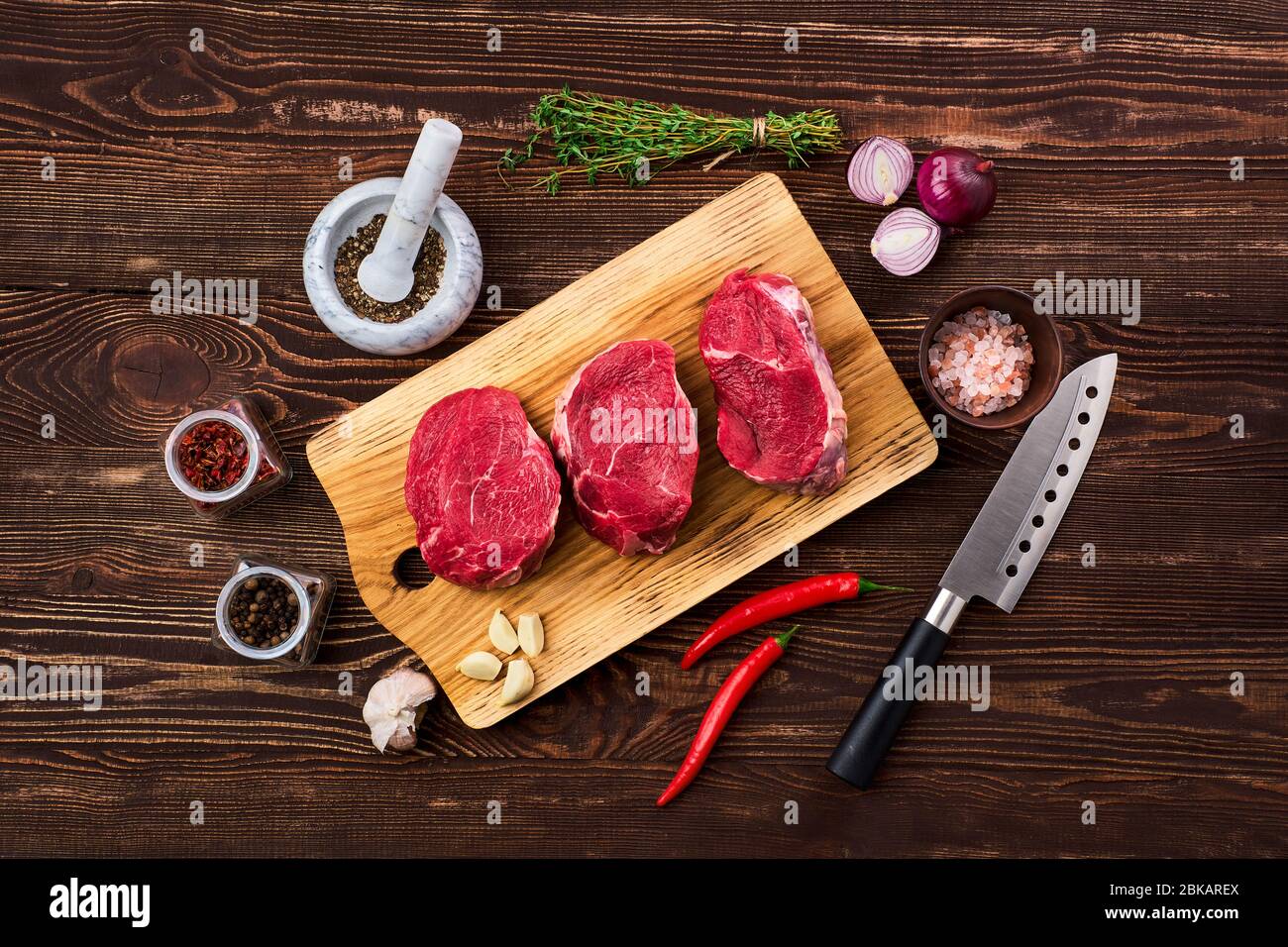 Top view of marinated beef fillet mignon with spice on wooden table Stock Photo