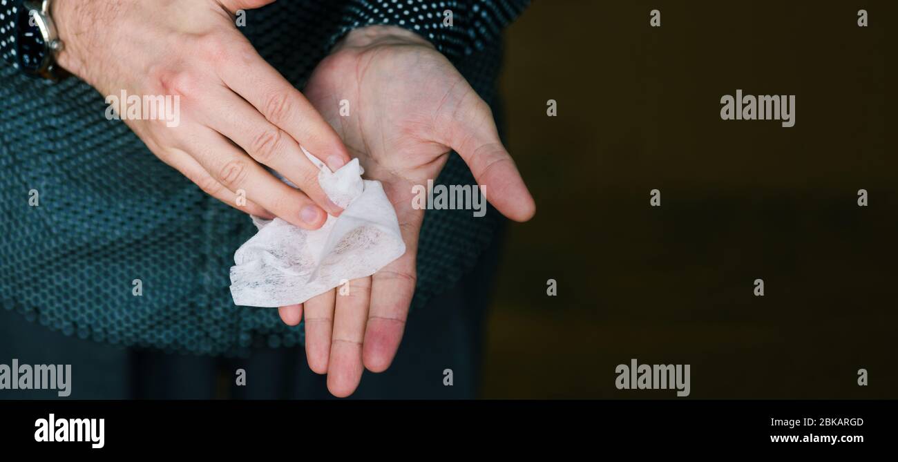 Hand cleaning with a white paper towel. Skin and face care. Means for