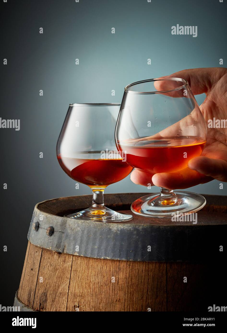 two glasses of cognac on old wooden barrel Stock Photo