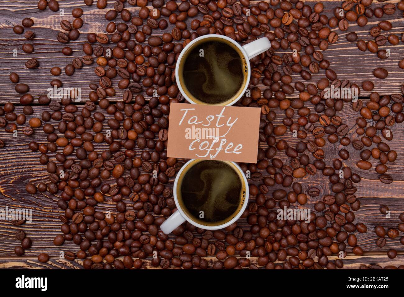 Tasty coffee cups on coffee beans. Stock Photo