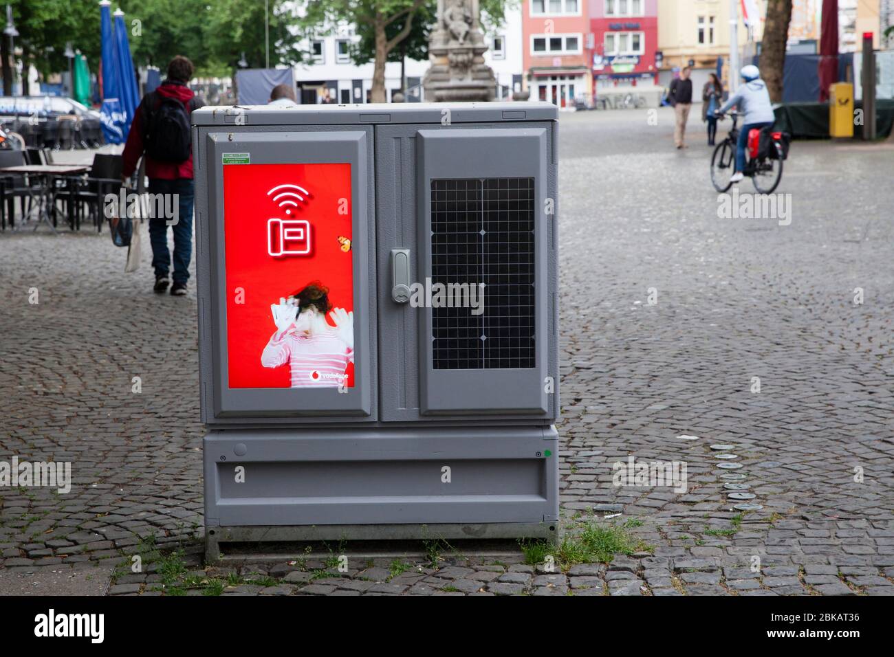 digital display for advertising and solar module on a switch cabinet at Alter Markt, Cologne, Germany.  digitales Display fuer Werbung und Solarmodul Stock Photo