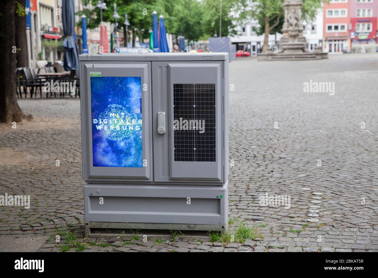 digital display for advertising and solar module on a switch cabinet at Alter Markt, Cologne, Germany.  digitales Display fuer Werbung und Solarmodul Stock Photo