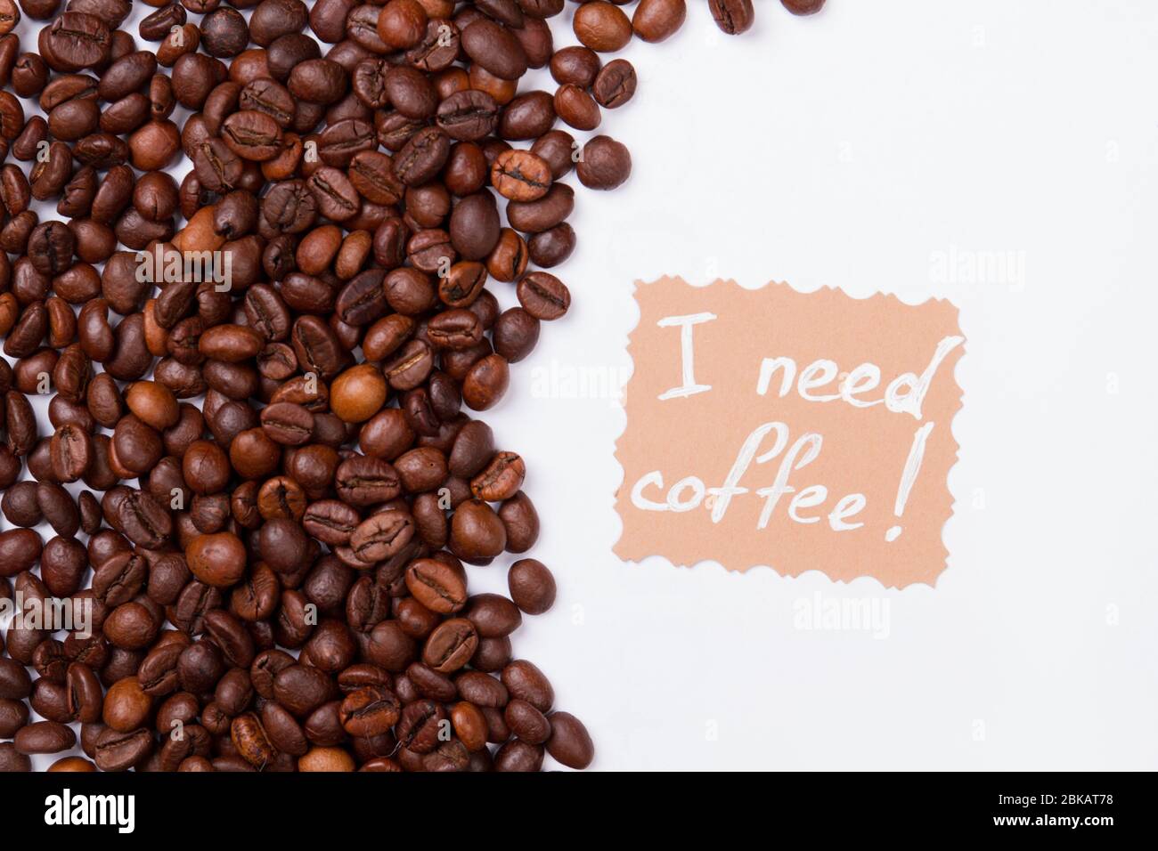 Many coffee beans on white background and message. Stock Photo