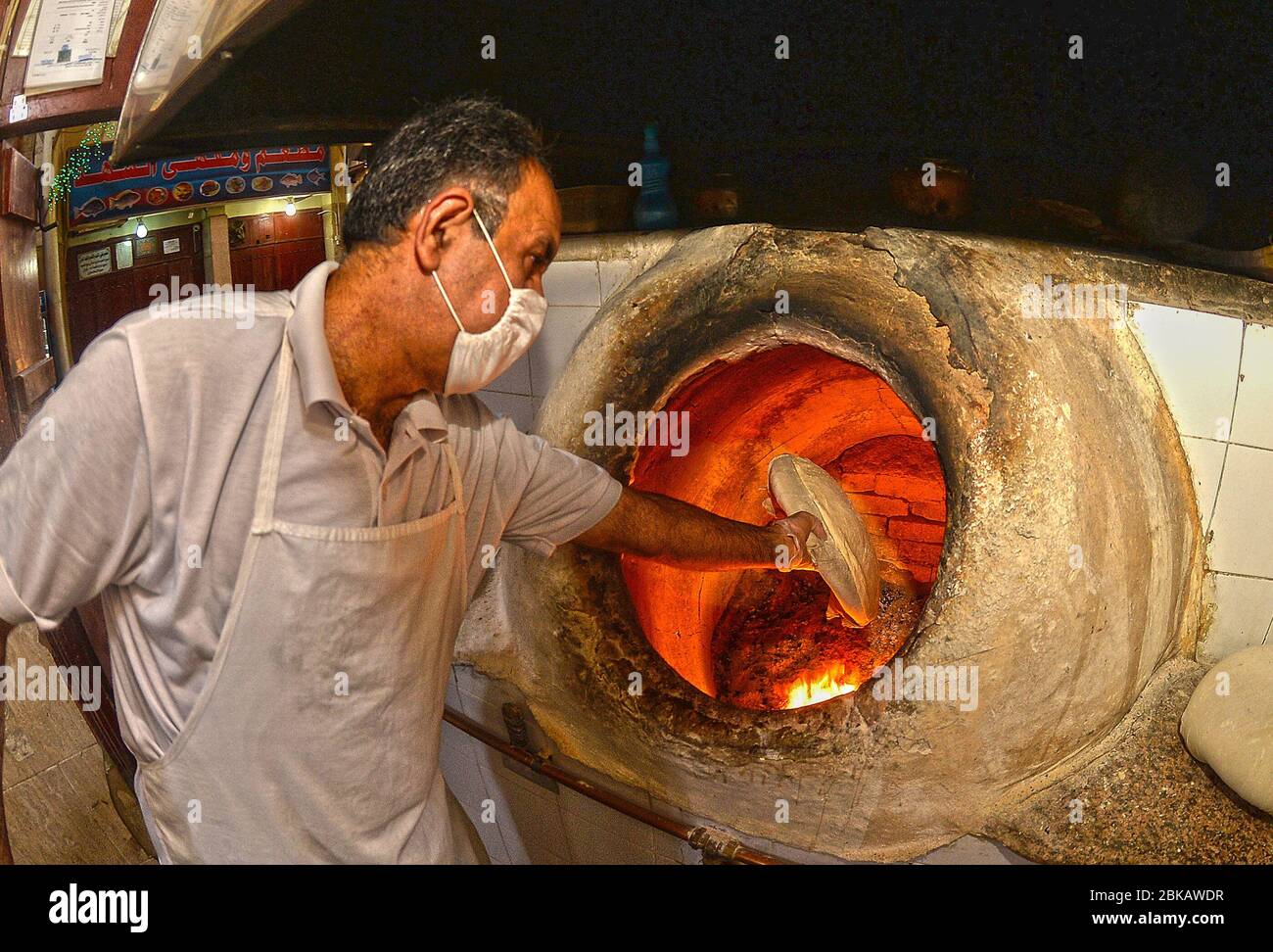 Kuwait City, Kuwait. 3rd May, 2020. A worker bakes bread at a bakery in