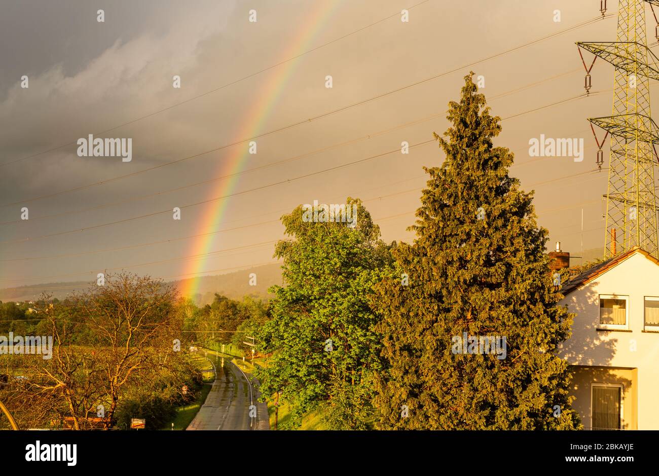Colorful rainbow in the sky. Storm weather. Fresh air. A romantic view. Areas outside the city. Cloudy sky. Ozone in the air. Stock Photo