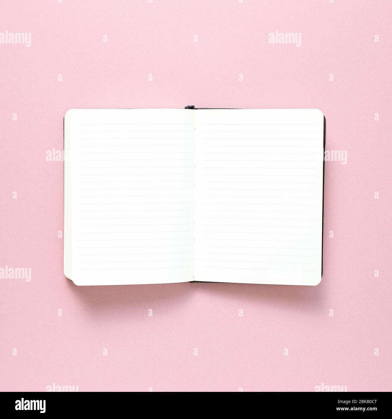 Empty notebook on pink background. top view, copy space Stock Photo