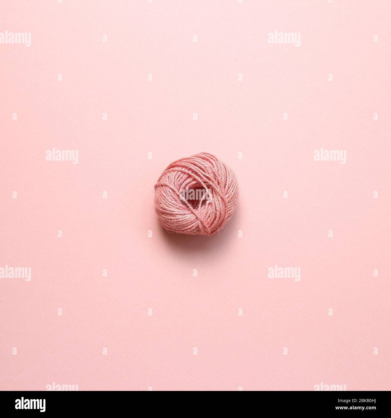 Pink string roll on pink background. top view Stock Photo - Alamy