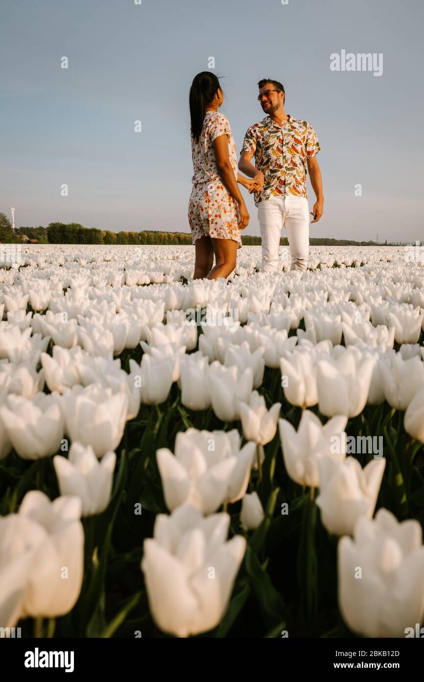 couple walking in flower field during Spring in the Netherlands, boy