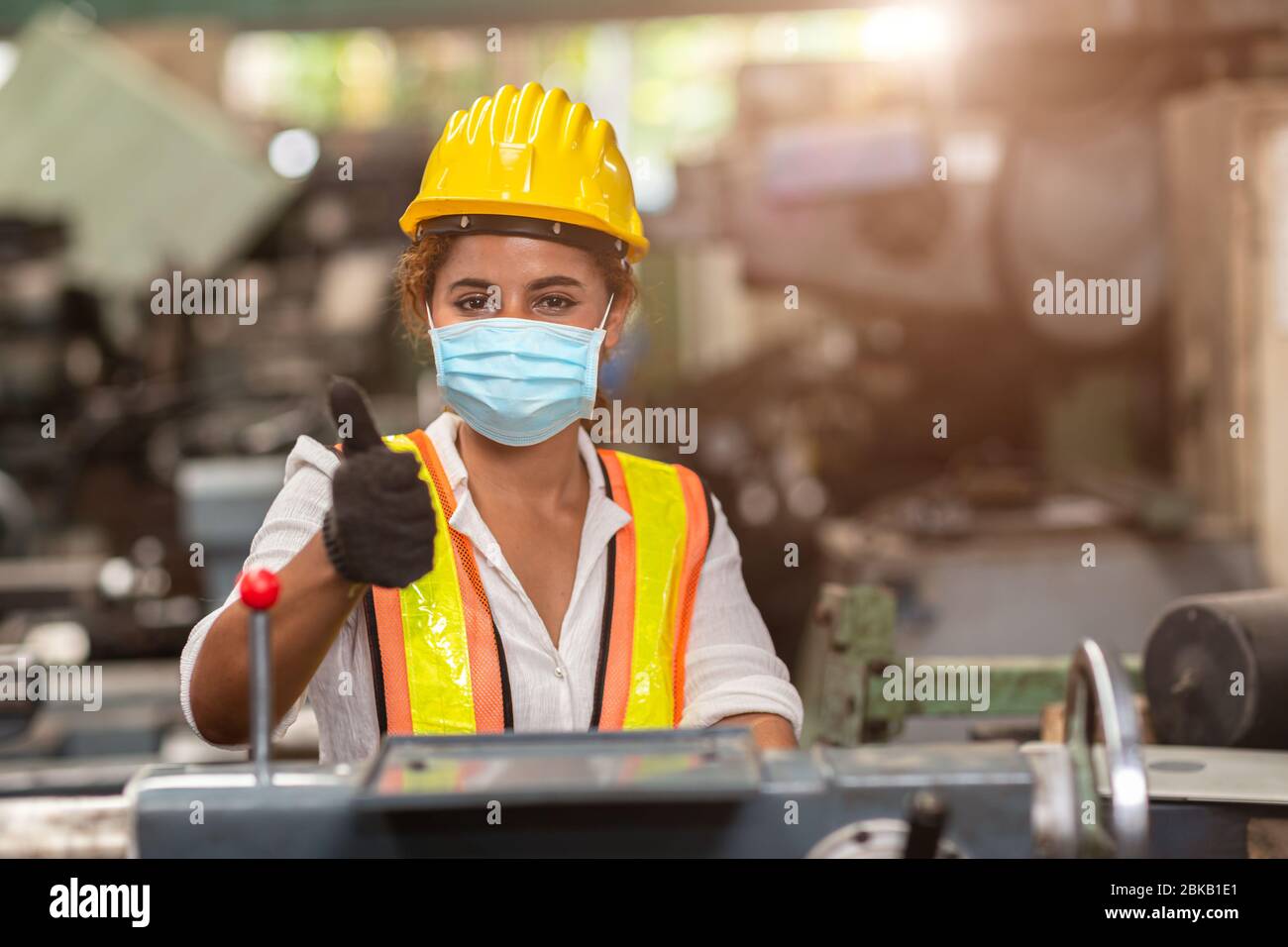 Women worker wear disposable face mask for protection Corona Virus Spreading and smoke dust air pollution filter in factory for healthy labor care. Stock Photo