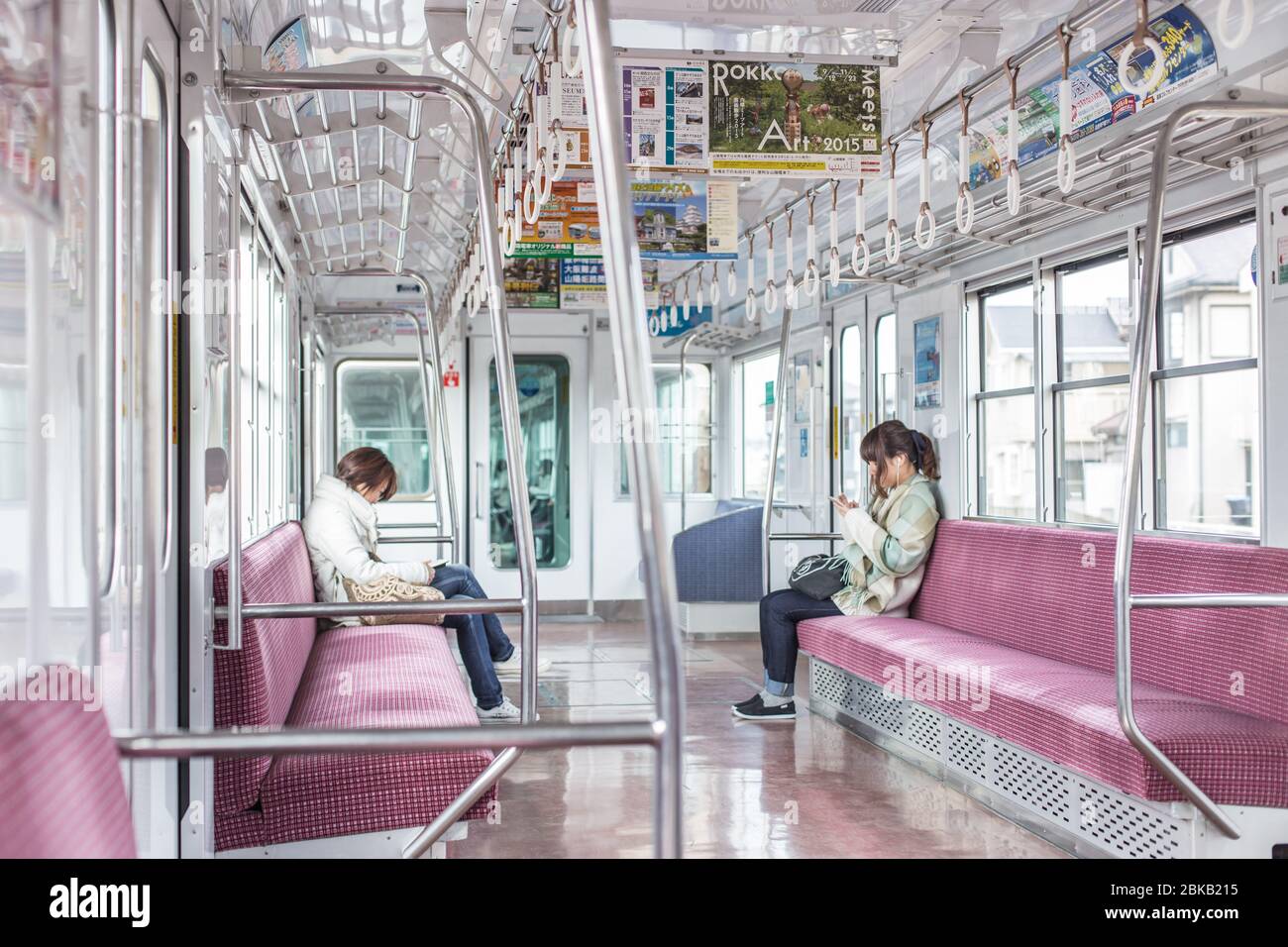 Quiet atmosphere in the Japanese local train with a few people while