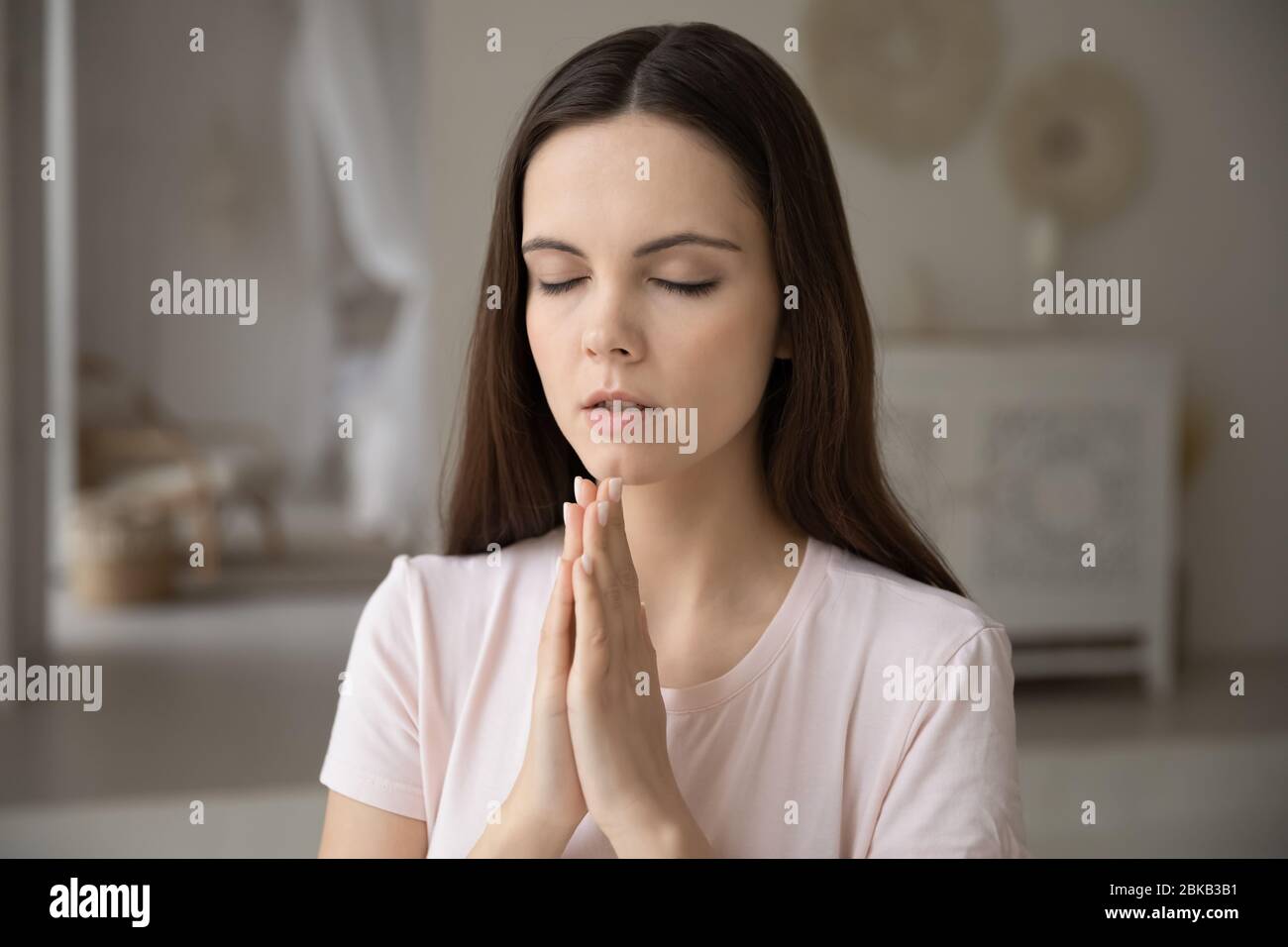 Religious young woman praying to God at home Stock Photo Alamy