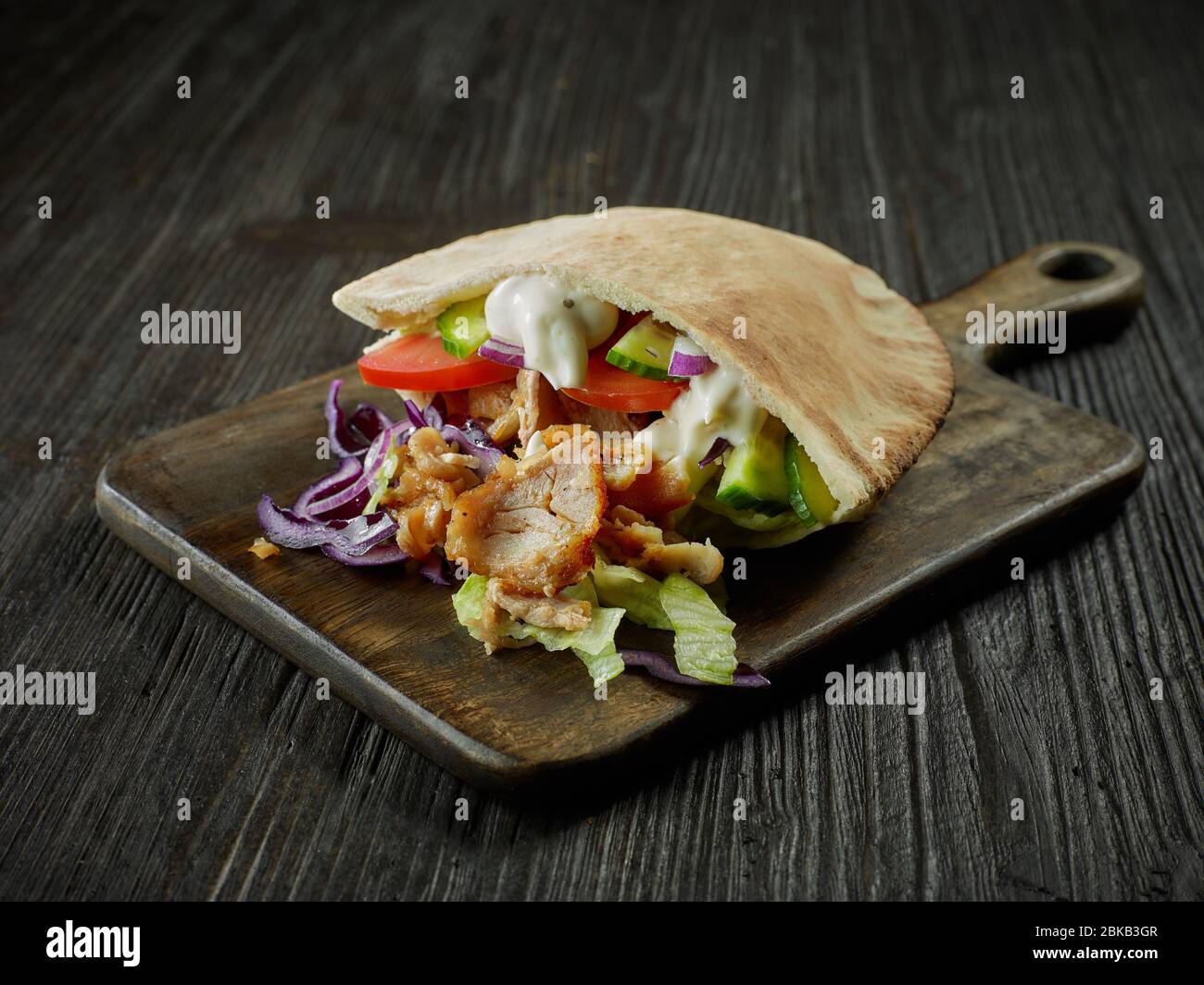 doner kebab on dark wooden kitchen table Stock Photo - Alamy