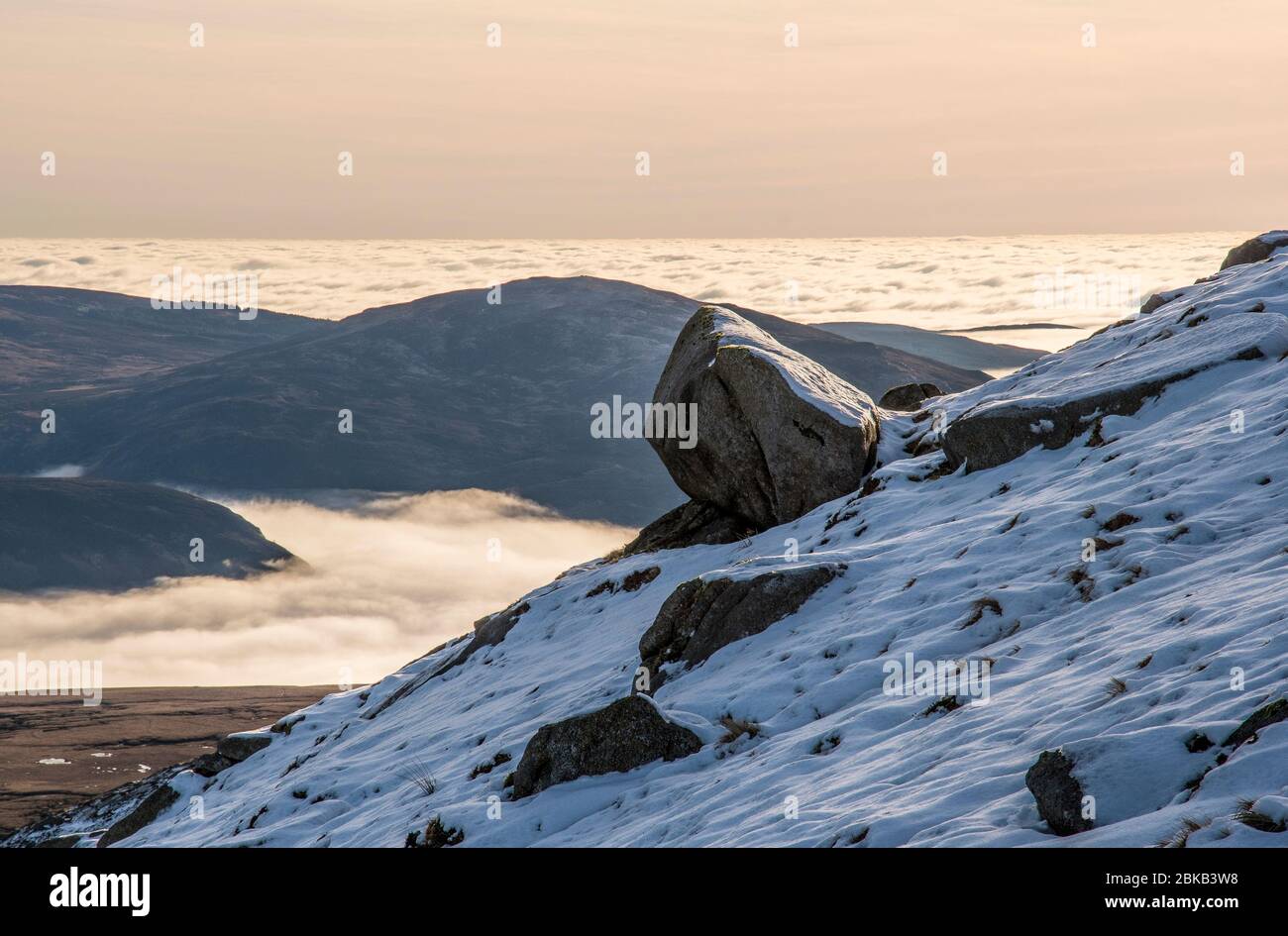 views to west from summit of ben nuis at sunset with cloud inversion in winter Stock Photo