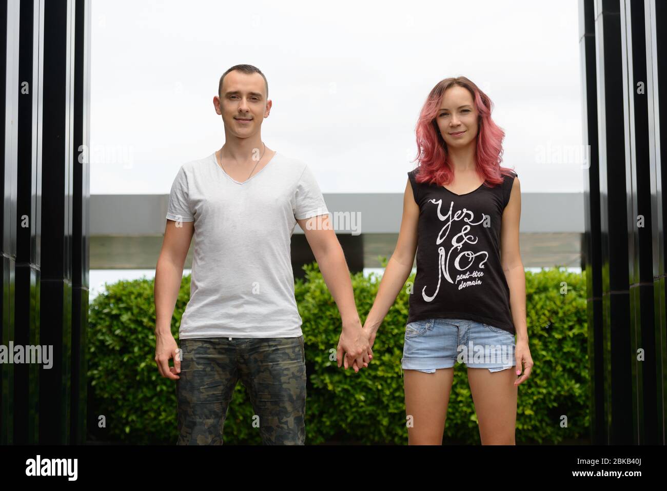 Happy couple holding hands together in the park outdoors Stock Photo ...