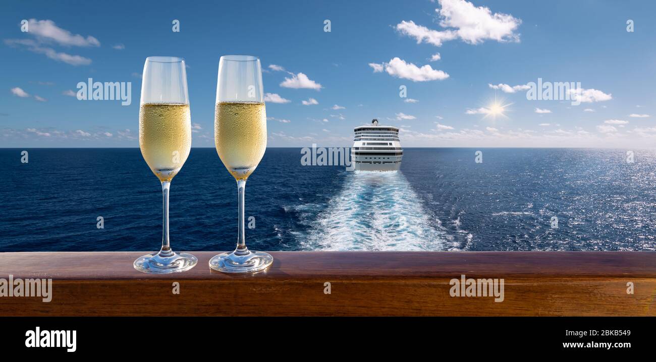 Luxury cruise travel with glasses of champagne on wooden railing. Stock Photo