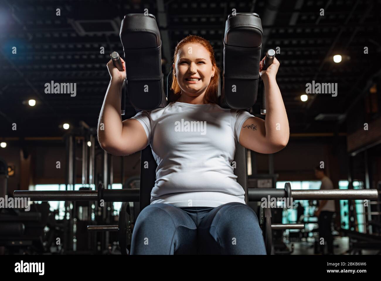 cropped view of purposeful overweight girl doing arms extension