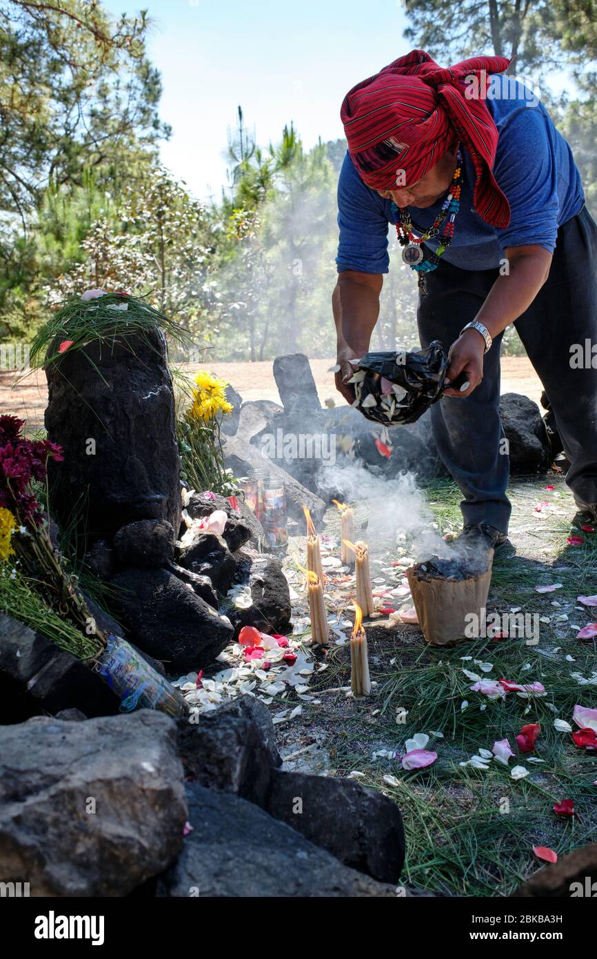 Shaman performing a Mayan healing ceremony for a family on the top of ...