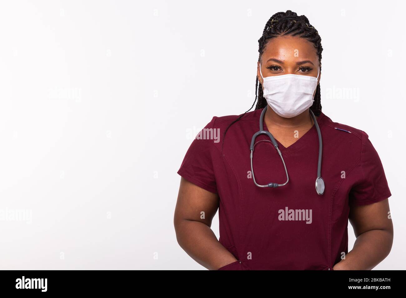 African american doctor in a medical mask over white background with ...
