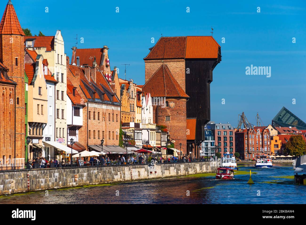 Gdansk old city in Poland with the oldest medieval port crane Zuraw and promenade along riverbank of Motlawa River Stock Photo