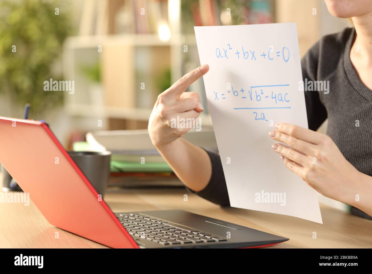 Close up of teacher woman hands teaching online lesson with laptop on videocall stting on a desk at home Stock Photo