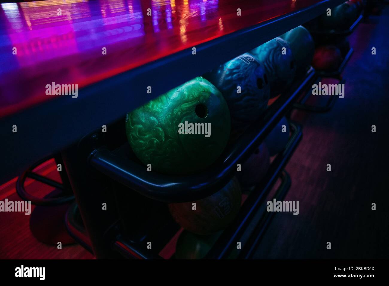 bowling balls under the table on which the light falls, background texture Stock Photo