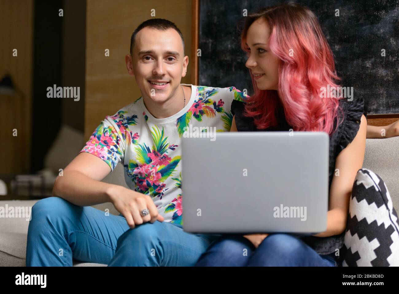 Portrait of happy couple using laptop together in the living room Stock ...