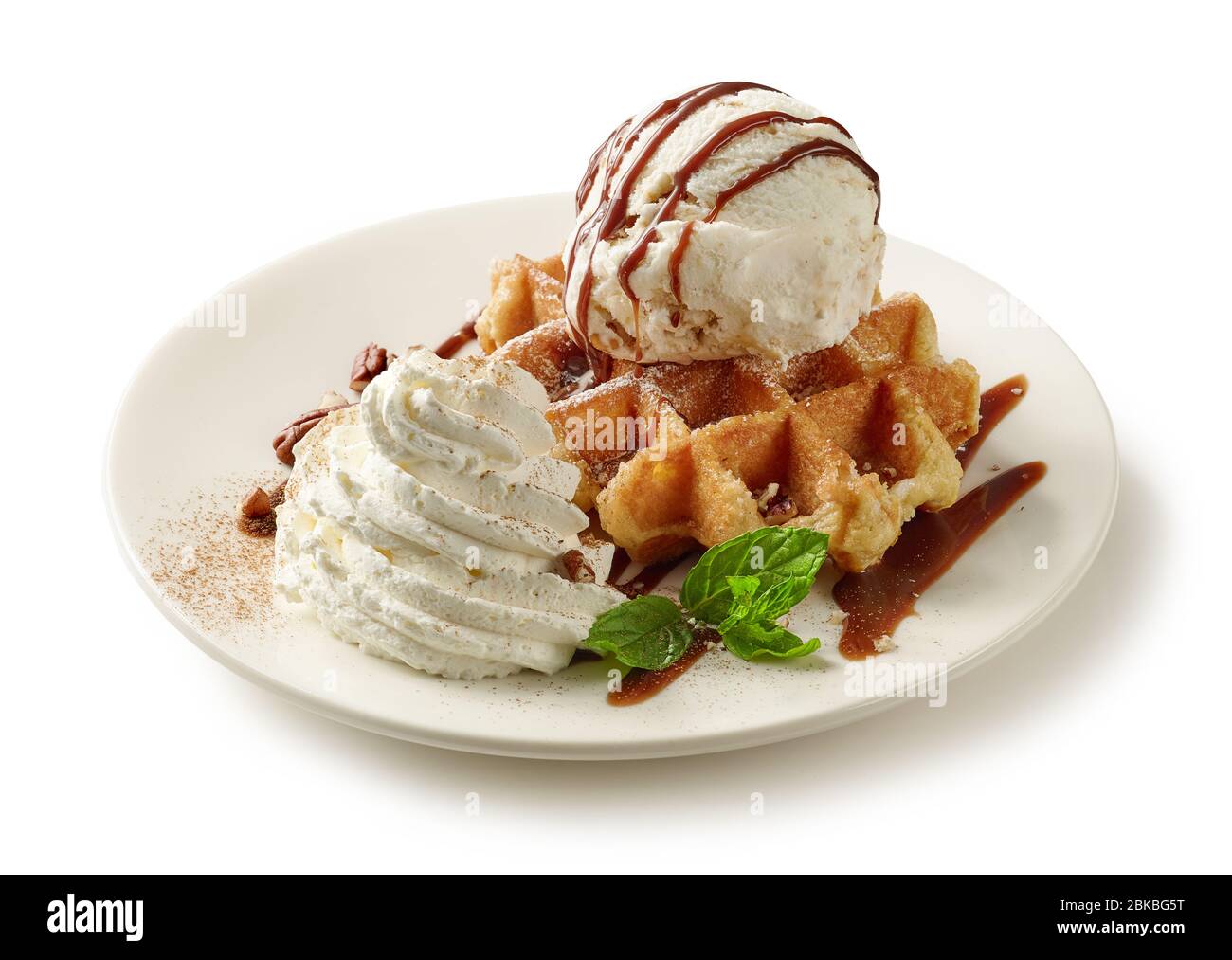 plate of belgian waffle dessert decorated with ice cream and chocolate