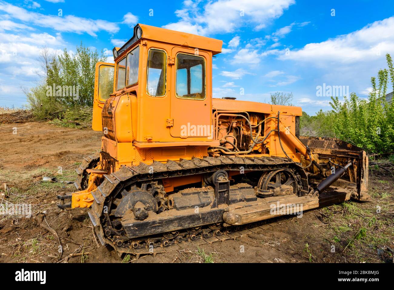 Industrial building construction site bulldozer leveling and moving