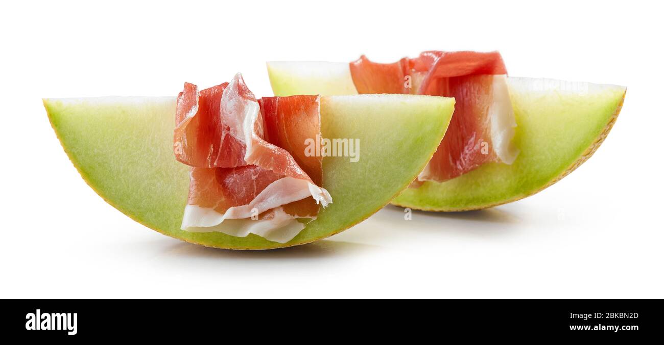 Melon slices with prosciutto ham isolated on white background Stock Photo