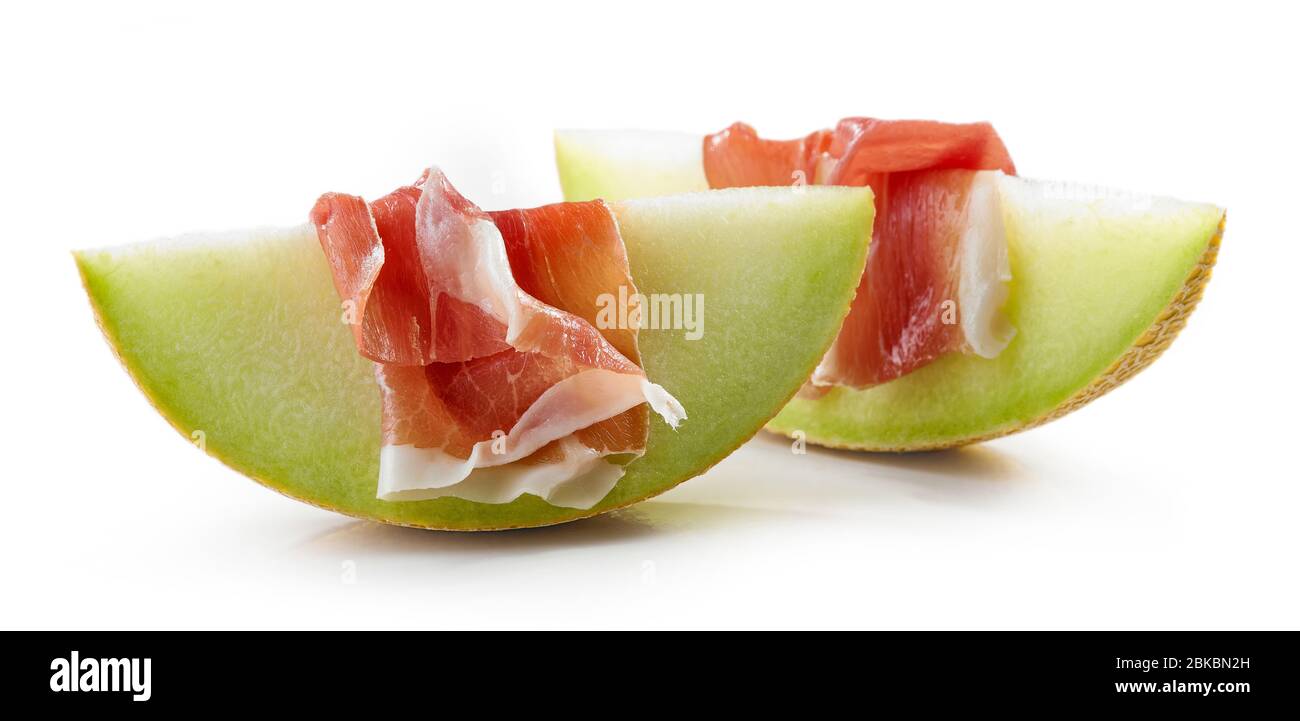 Melon slices with prosciutto ham isolated on white background Stock Photo