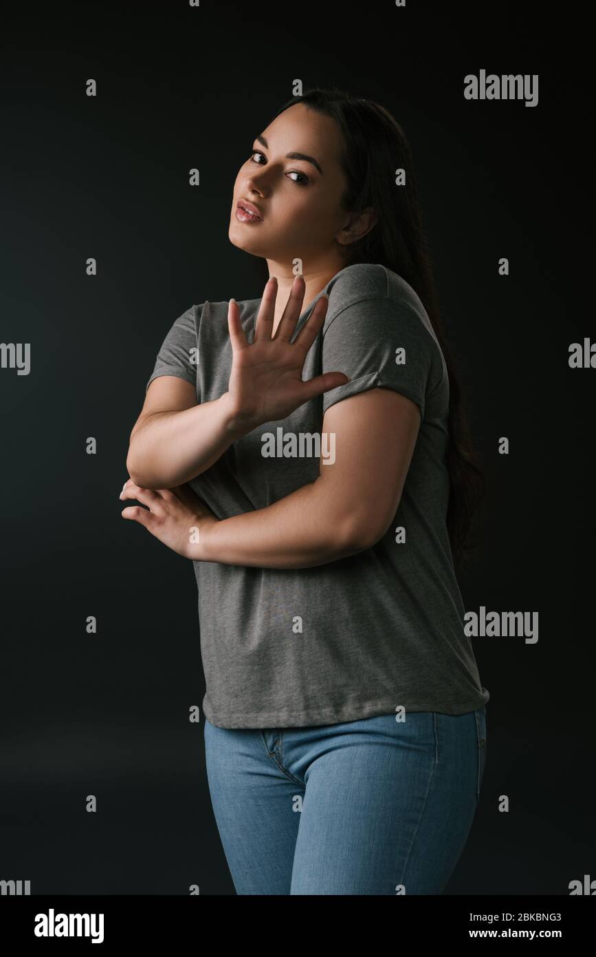 Confused plus size with stop gesture on black background Stock Photo