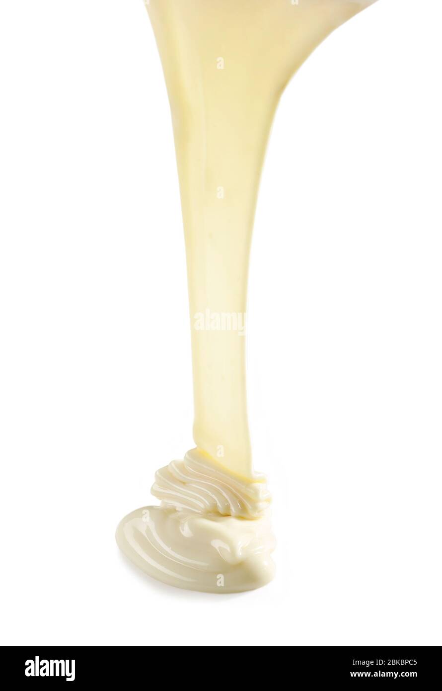 pouring melted white chocolate isolated on white background Stock Photo