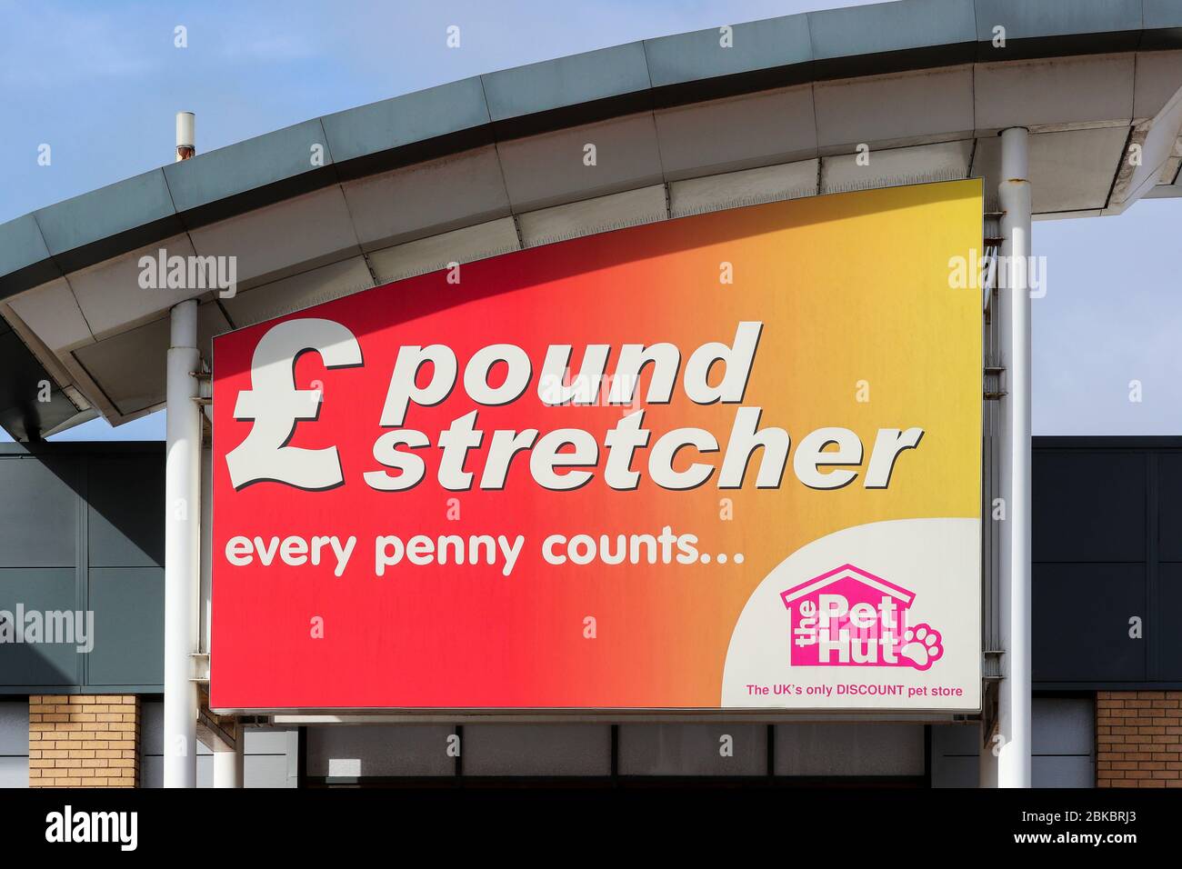Poundstretcher and The Pet Hut company logo above and entrance to a shop mall, Irvine, UK Stock Photo