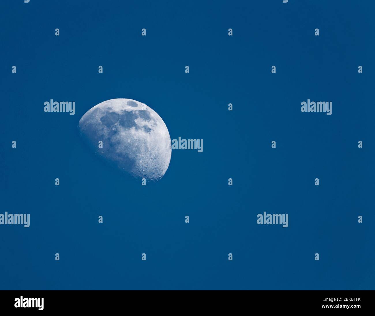 Waxing moon in the early evening sky Stock Photo