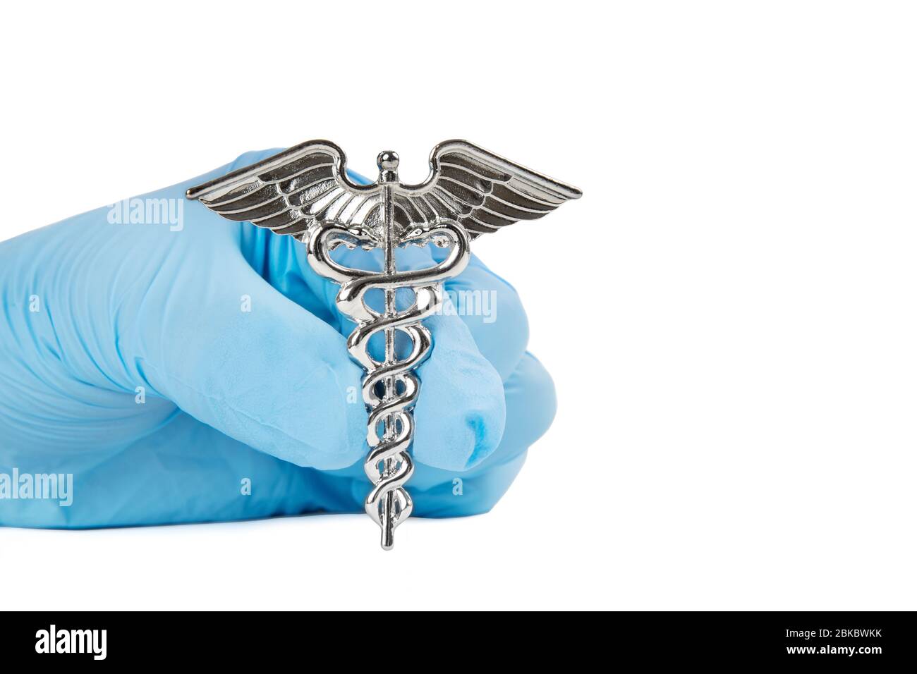 Close-up shot of a Caduceus symbol in a female hand wearing a blue nitrile glove isolated on white. Stock Photo