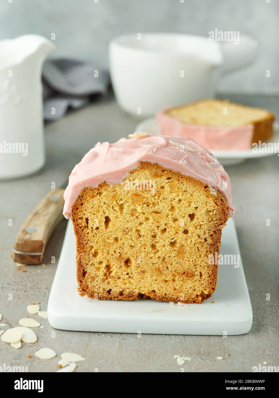 freshly baked sweet bread with pink chocolate on grey table Stock Photo