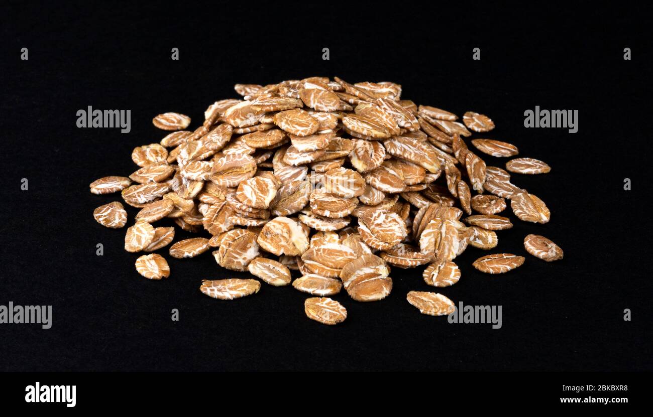 Heap of oat flakes isolated on black background Stock Photo