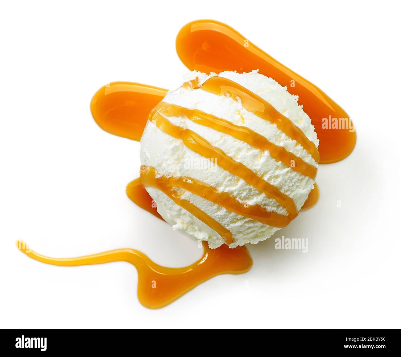 vanilla ice cream decorated with caramel sauce isolated on white ...