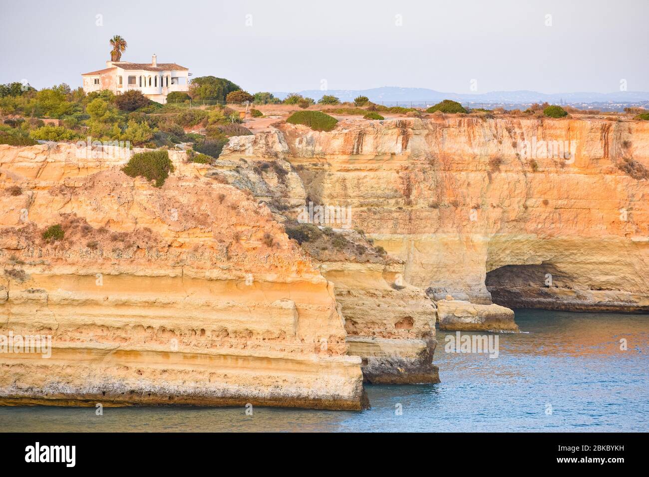 Small summer house on top of the cliffs, overlooking the sea. Algarve, Portugal Stock Photo